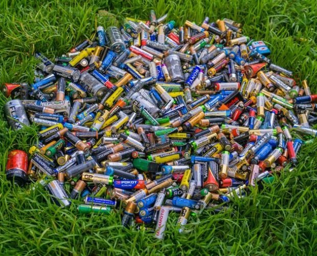 heap-old-used-discarded-aa-cells-other-electric-batteries-grass_533998-3159